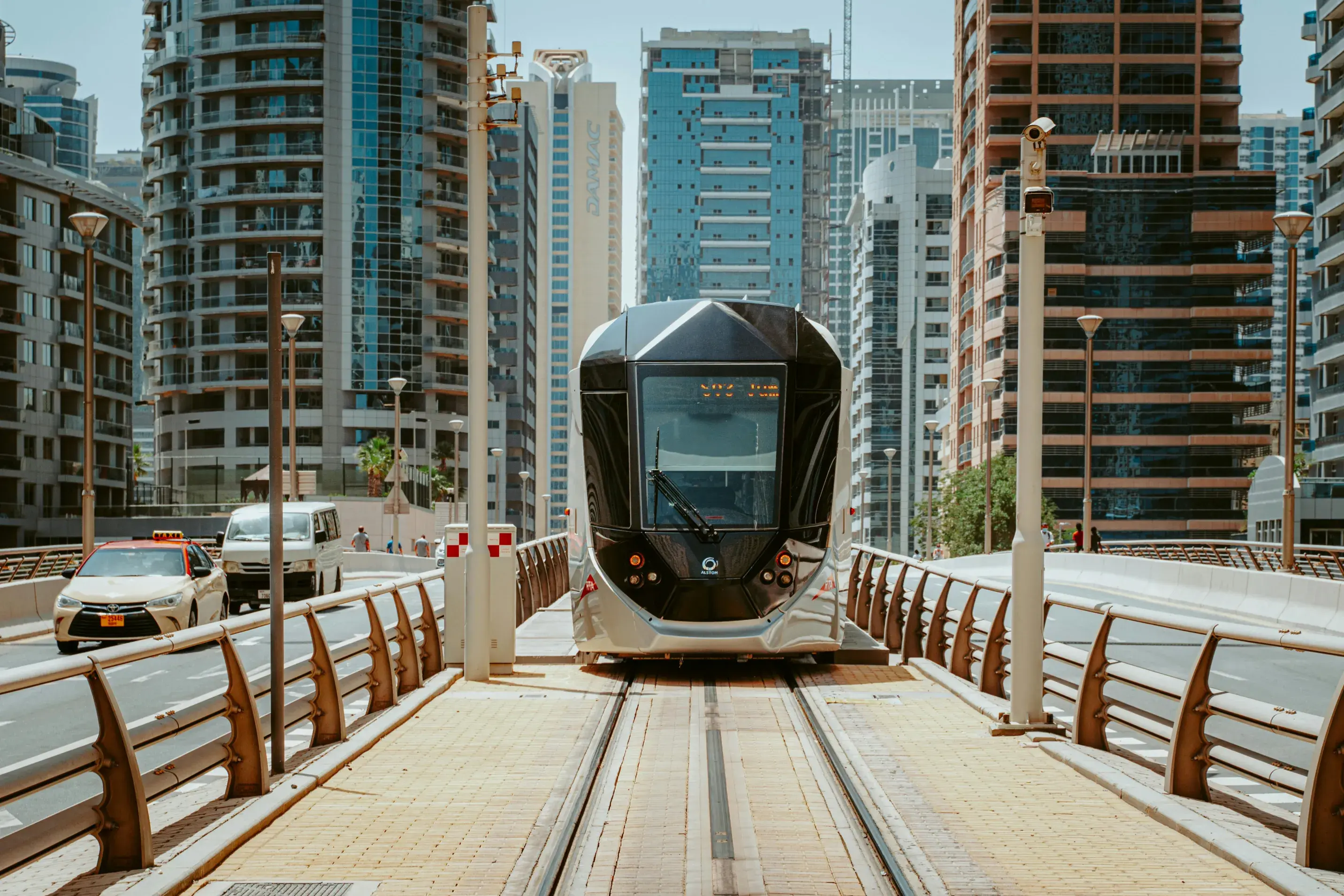 A Tram In The Middle Of The Road Near Buildings