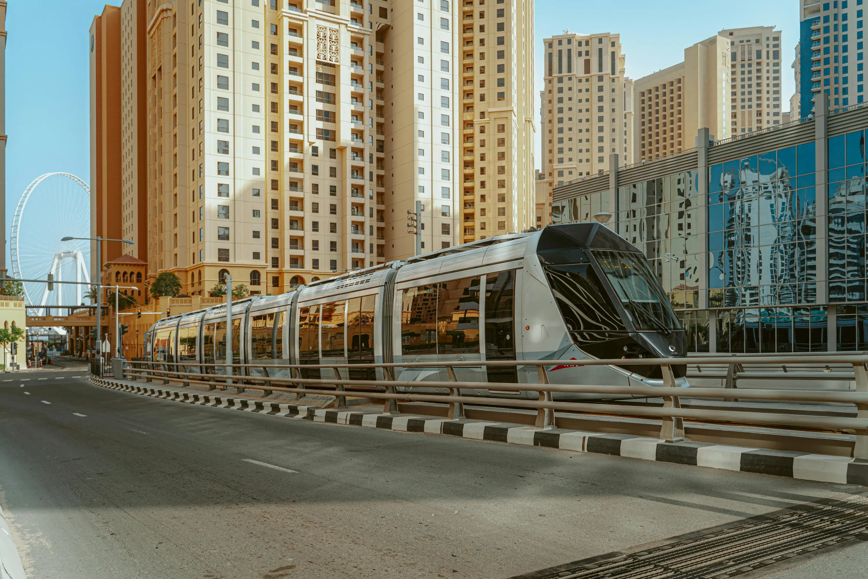 White And Blue Tram Near High Rise Buildings